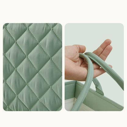 Green quilted bag with diamond pattern and handle held by a hand on a light green background