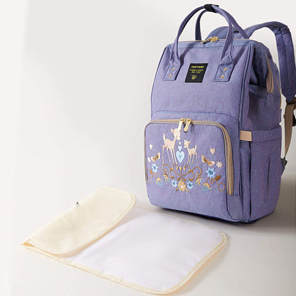 Sunveno Classic Embroidered Diaper Backpack - Purple Deer and a matching changing pad on a light background