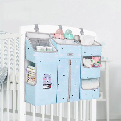 Sunveno 3-in-1 Crib Organizer Blue hanging over a crib with various items inside