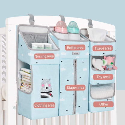 Sunveno 3-in-1 Crib Organizer with labeled sections for bottles, tissues, nursing, clothing, diapers, toys, and other items against a light blue background.