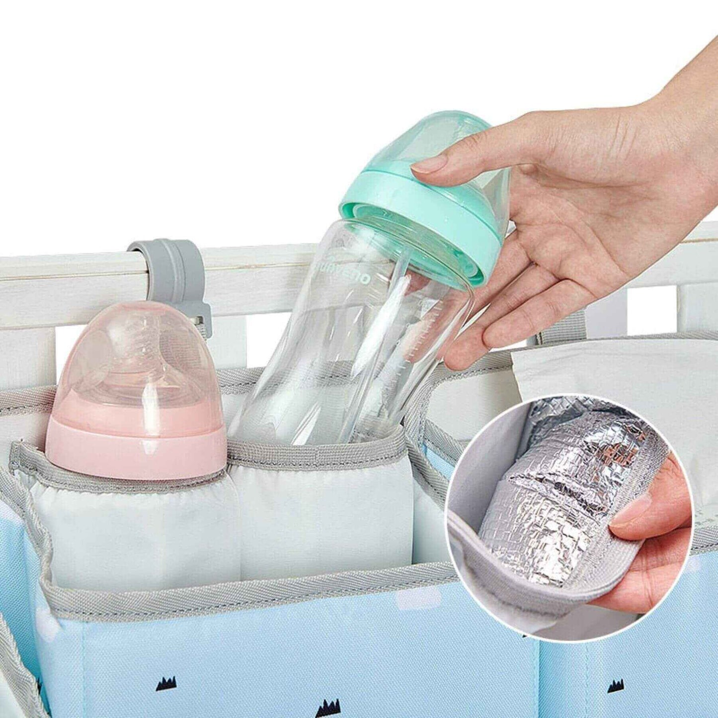 Baby bottle in Sunveno 3-in-1 Crib Organizer with a hand holding the bottle, showing the insulation feature.