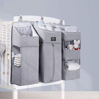 Crib with Sunveno 3-in-1 Crib Organizer Gray containing baby items on a light gray background