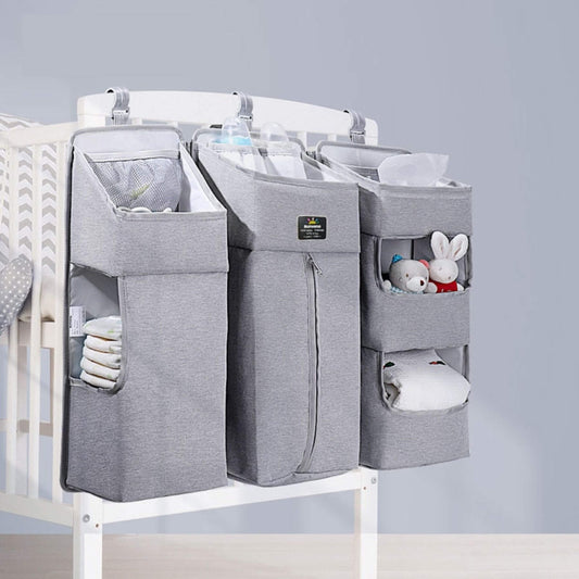 Crib with Sunveno 3-in-1 Crib Organizer Gray containing baby items on a light gray background
