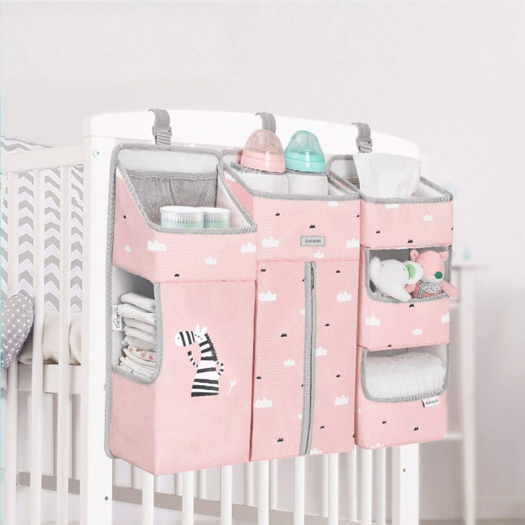 Sunveno 3-in-1 Crib Organizer Pink hanging on a crib with various items inside