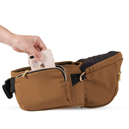 Sunveno Easy Hold Baby Hipseat Carrier - Brown with a person placing a phone into one of its pockets on a white background