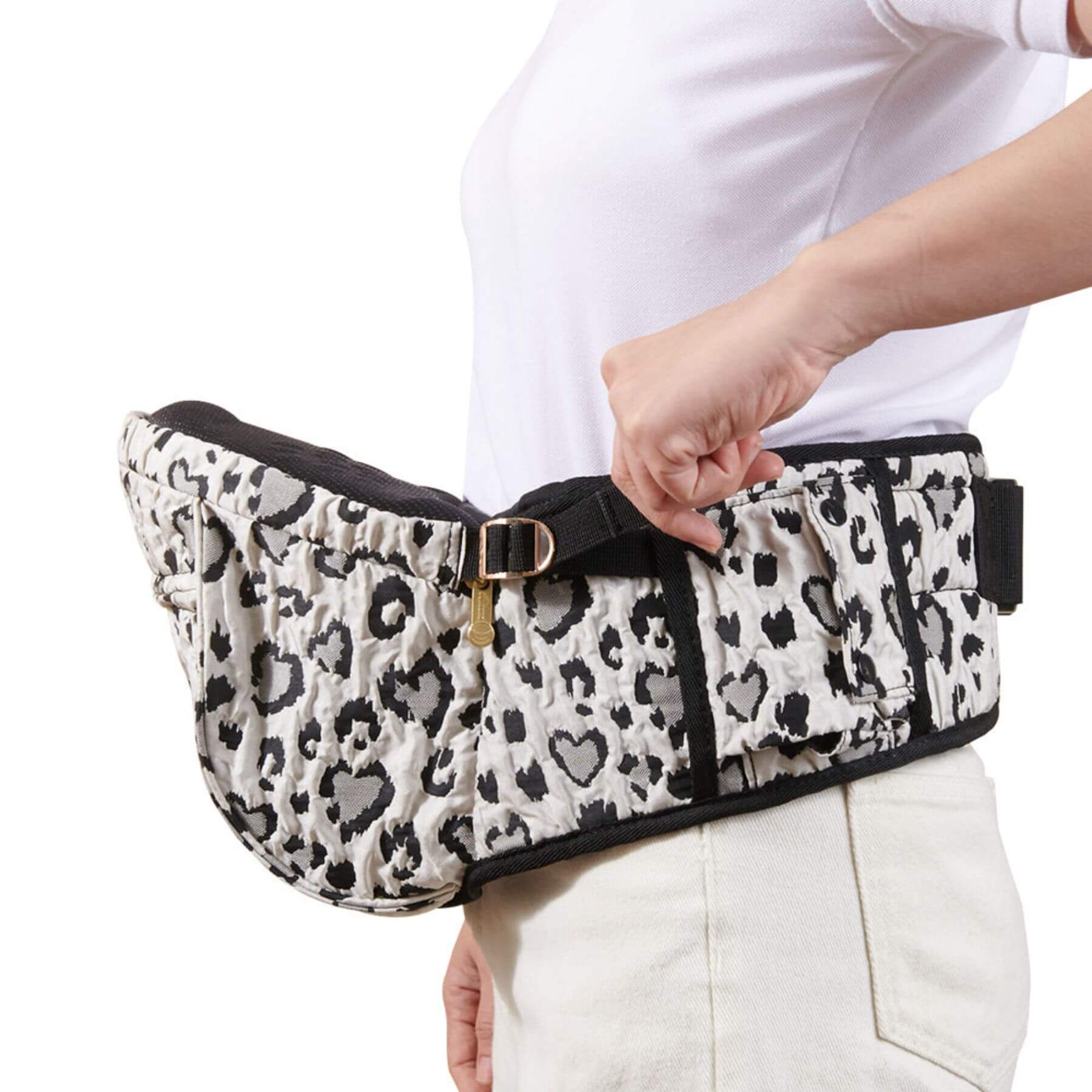 Sunveno Easy Hold Baby Hipseat Carrier held by a person wearing a white shirt and light-colored pants.