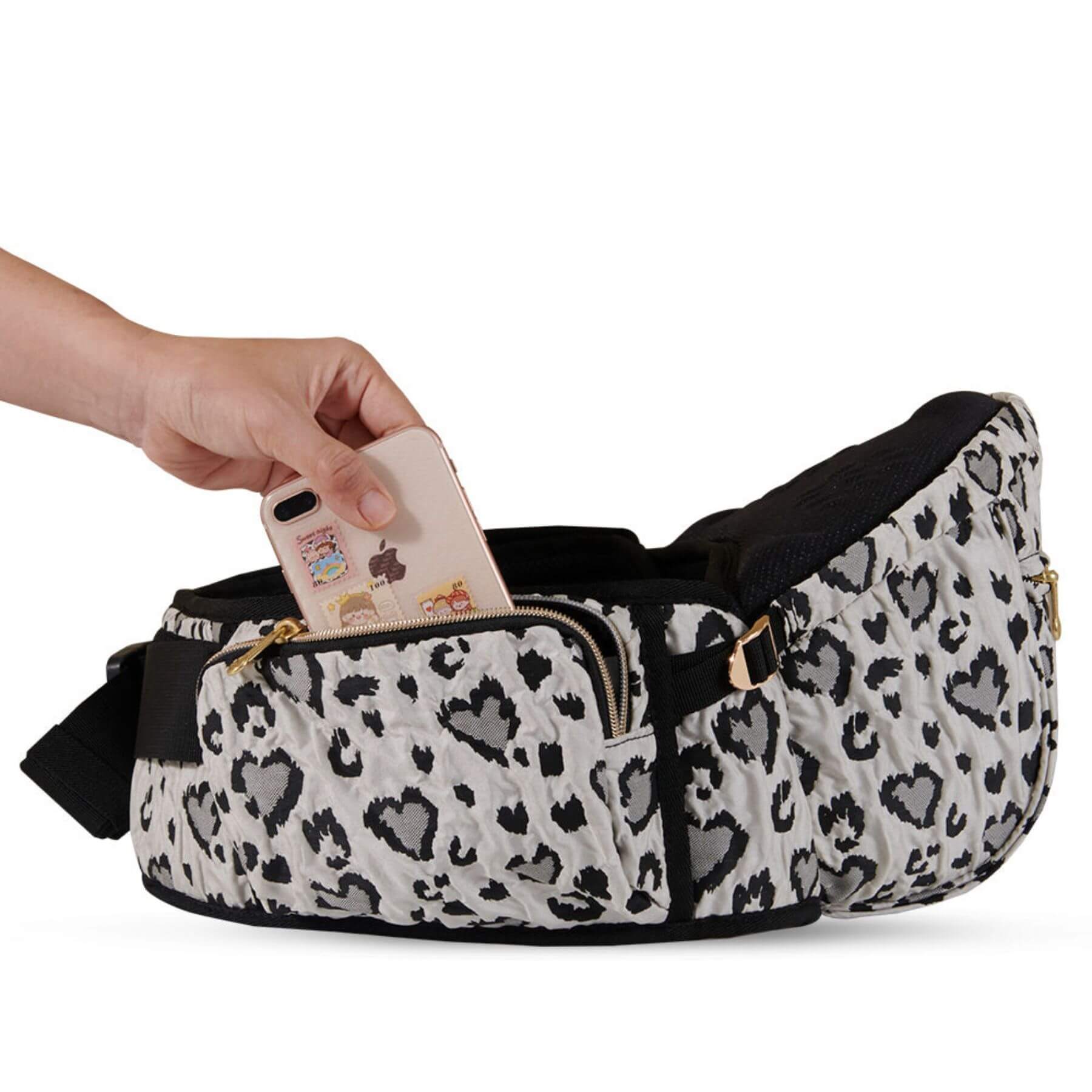 Sunveno Easy Hold Baby Hipseat Carrier with a hand reaching in to place a phone inside on a white background