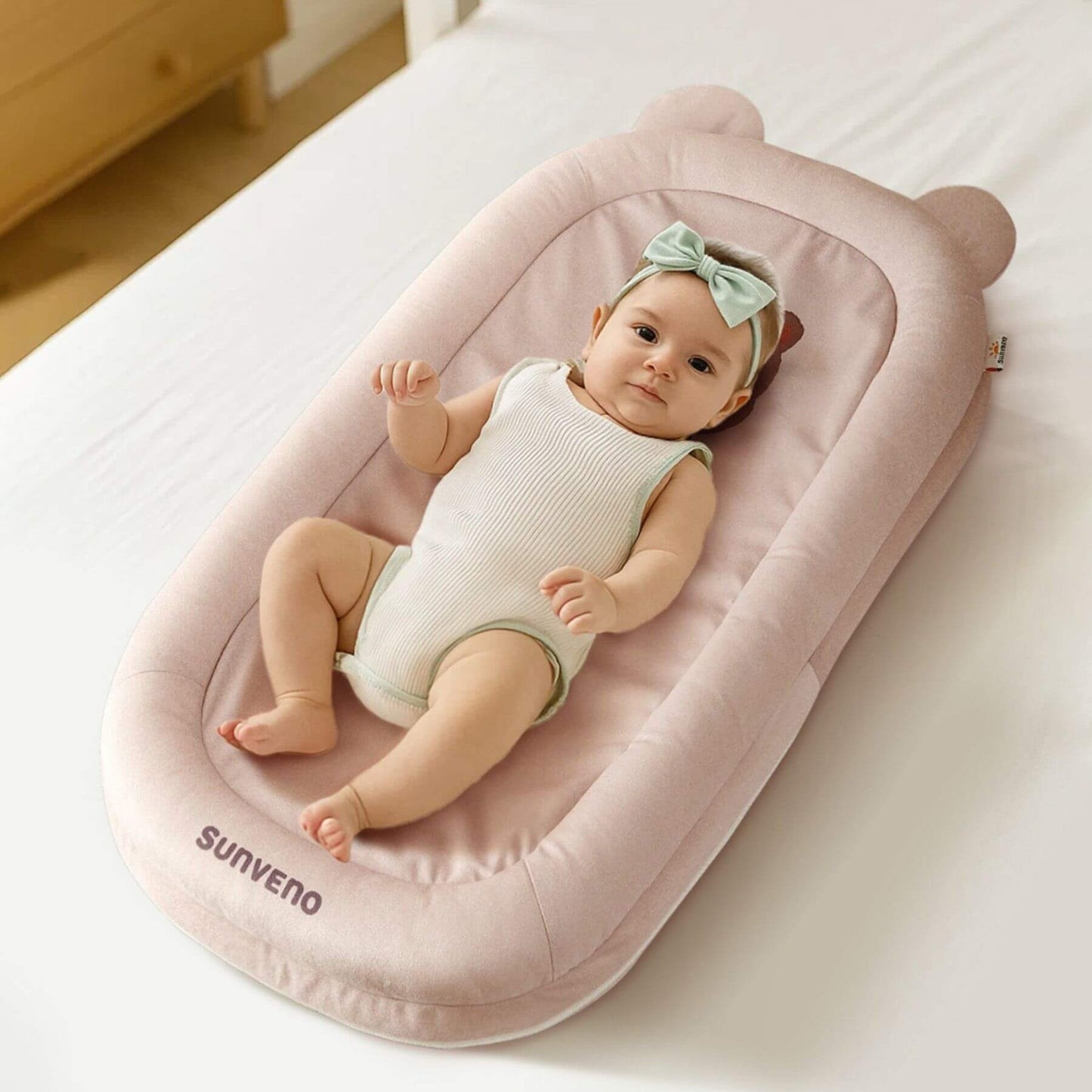Baby sleeps on Sunveno Baby Lounger for Newborns - Brown