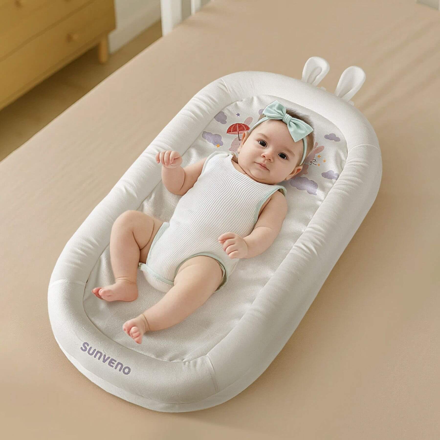 Baby sleeping on Sunveno Baby Lounger for Newborns - White