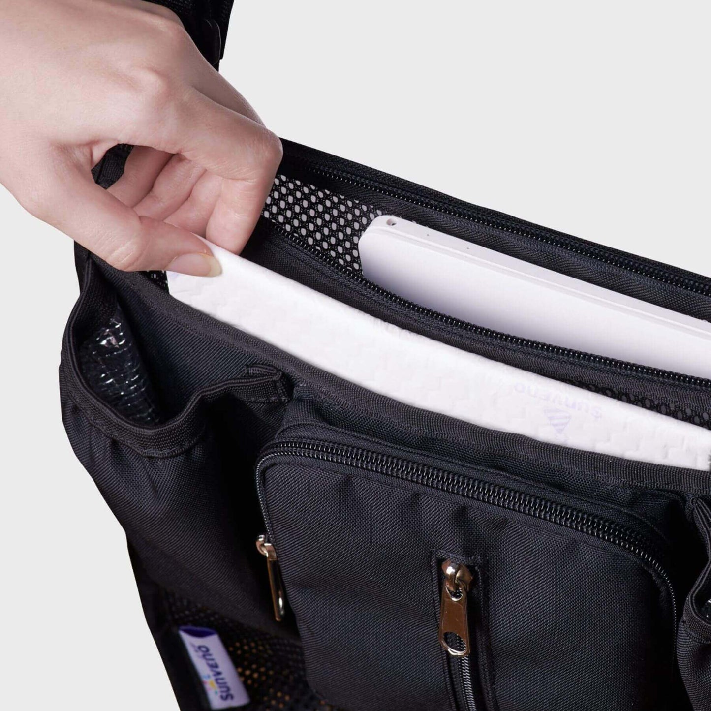 Hand getting tissues from Sunveno Mesh Stroller Organizer