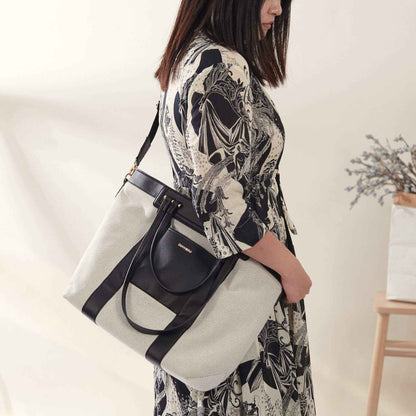 Woman holding Sunveno The Mommy Tote Bag - Black with a neutral background