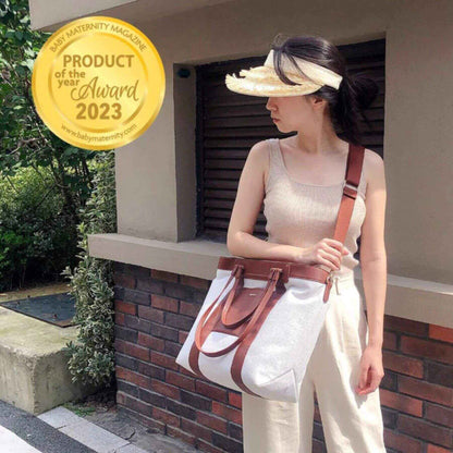 Woman holding Sunveno The Mommy Tote Bag - Brown with a 'Product of the Year Award 2023' badge in the corner.