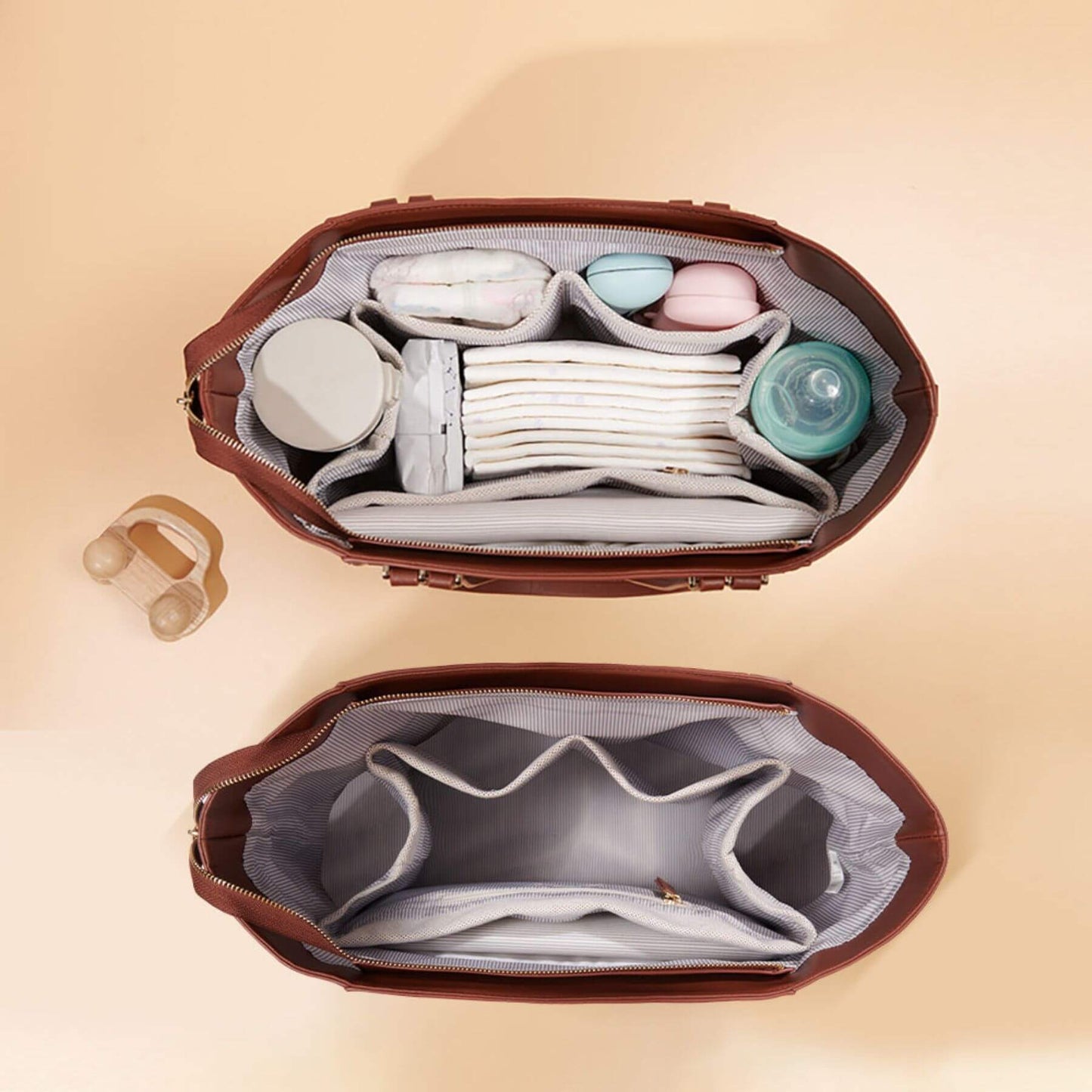 Open Sunveno The Mommy Tote Bag - Brown with baby items on a beige background