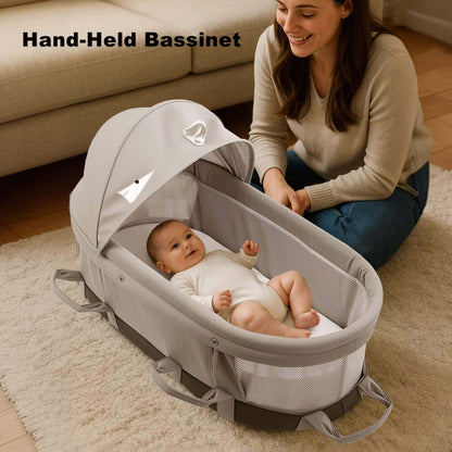 Woman with a baby in Sunveno Portable Baby Bassinet on a carpeted floor.