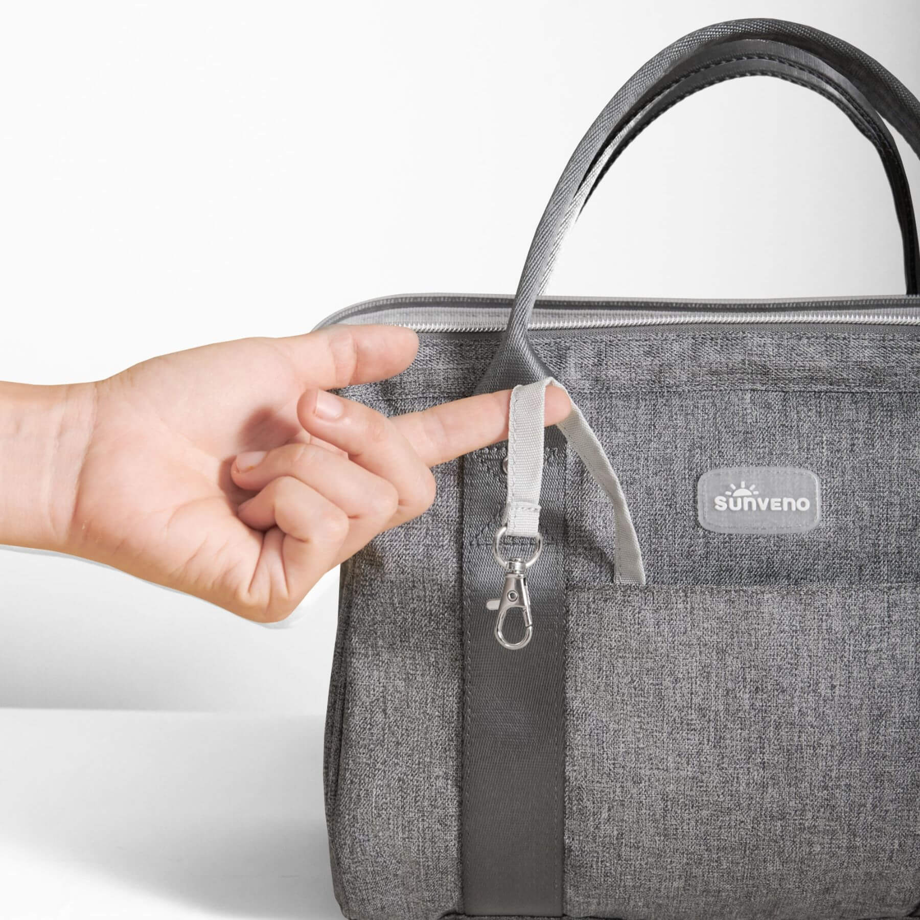 Sunveno Small Crossbody Diaper Bag with a hand holding the strap, featuring the Sunveno brand.