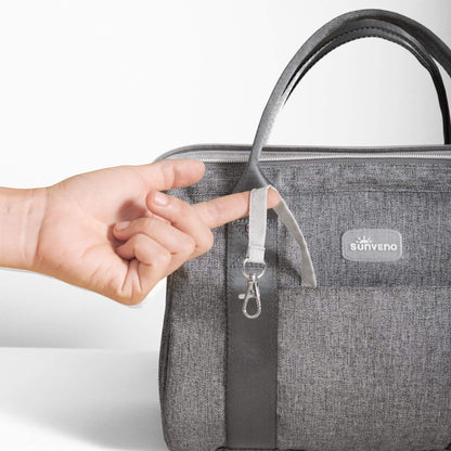 Sunveno Small Crossbody Diaper Bag with a hand holding the strap, featuring the Sunveno brand.