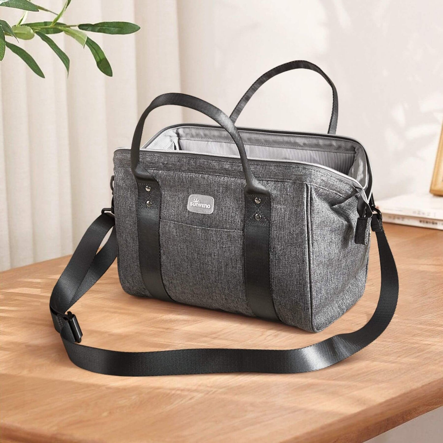 Sunveno Small Crossbody Diaper Bag on a wooden surface