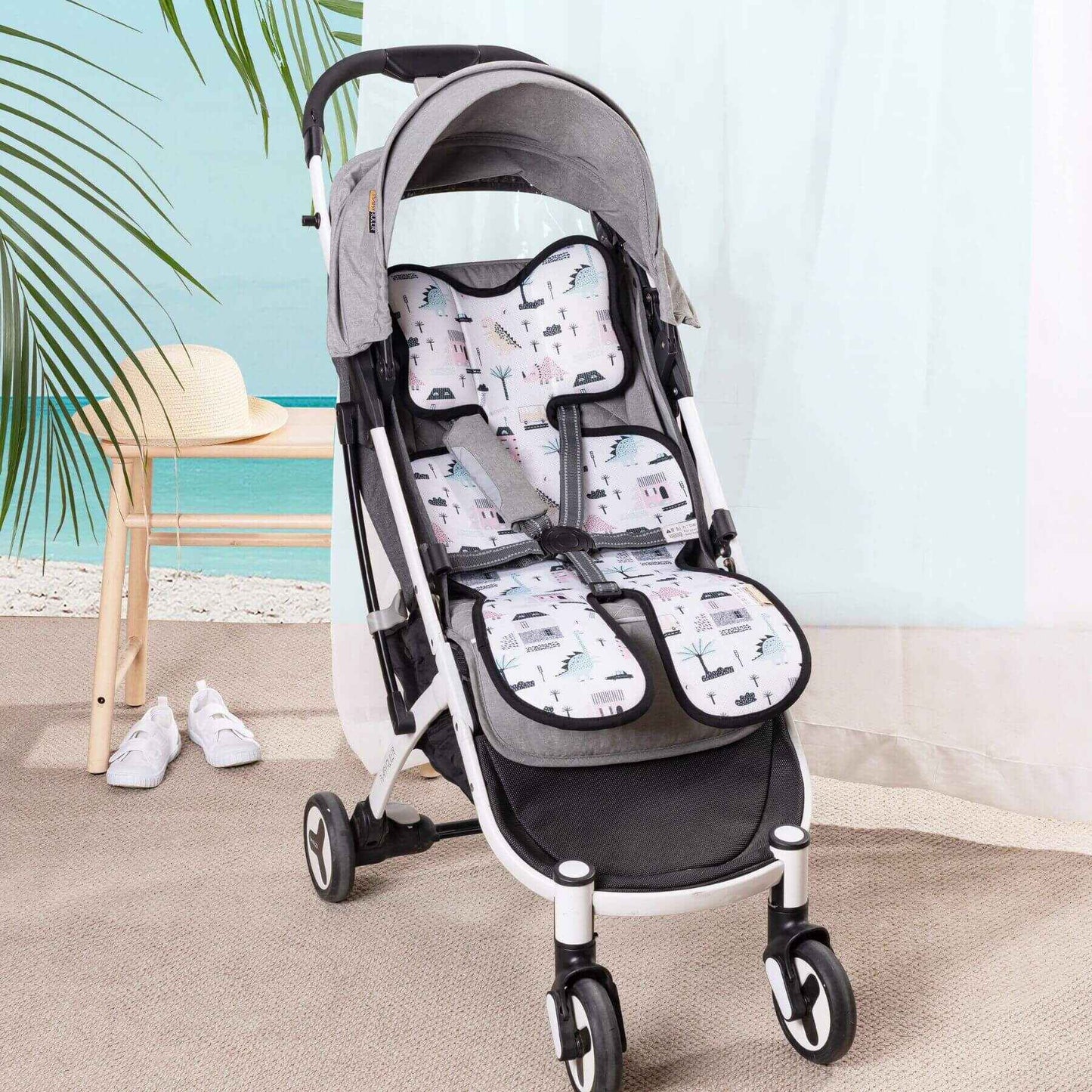 Baby stroller with Sunveno Breathable Stroller Pad in a room with a beach view