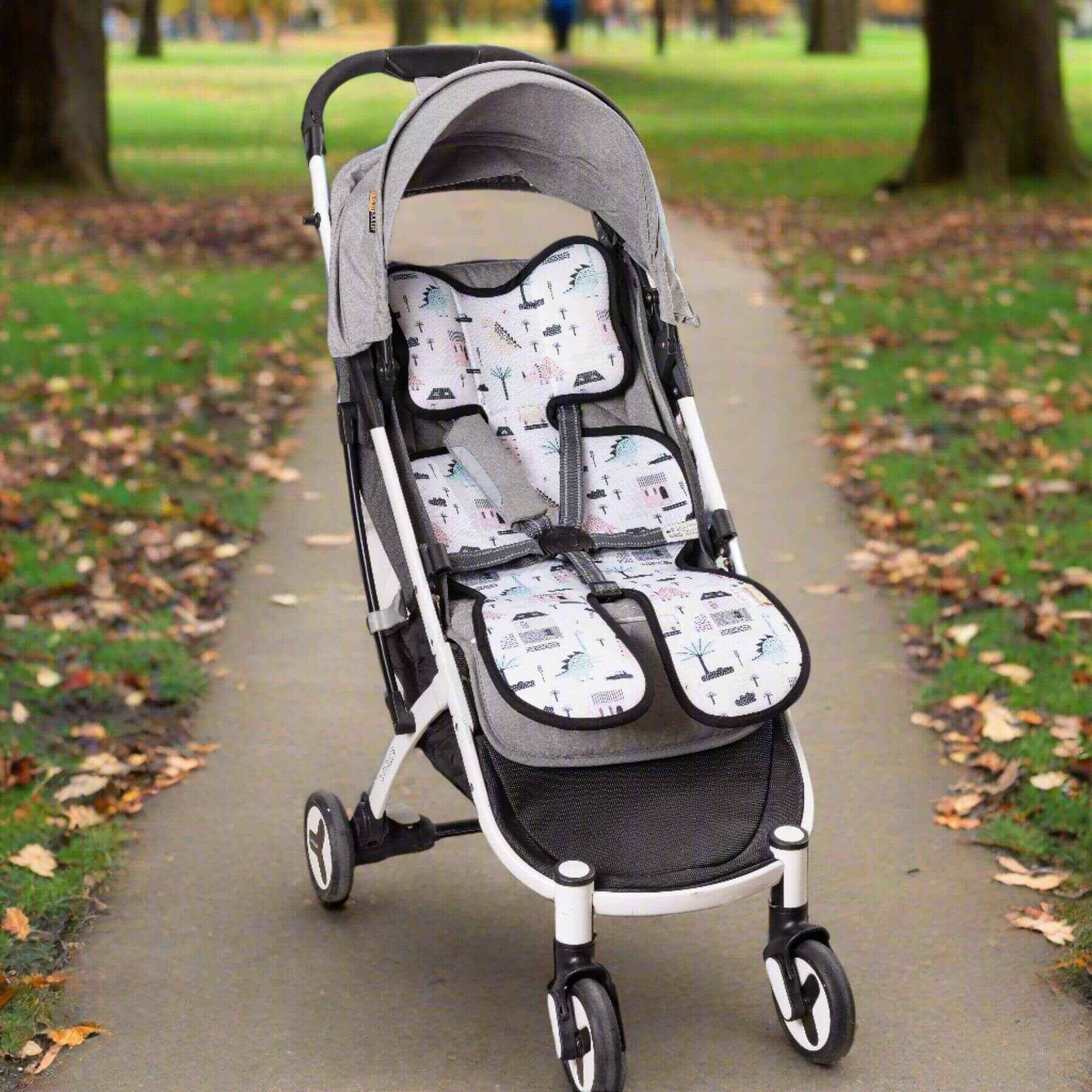 Stroller with Sunveno Breathable Stroller Pad on a paved path in a park
