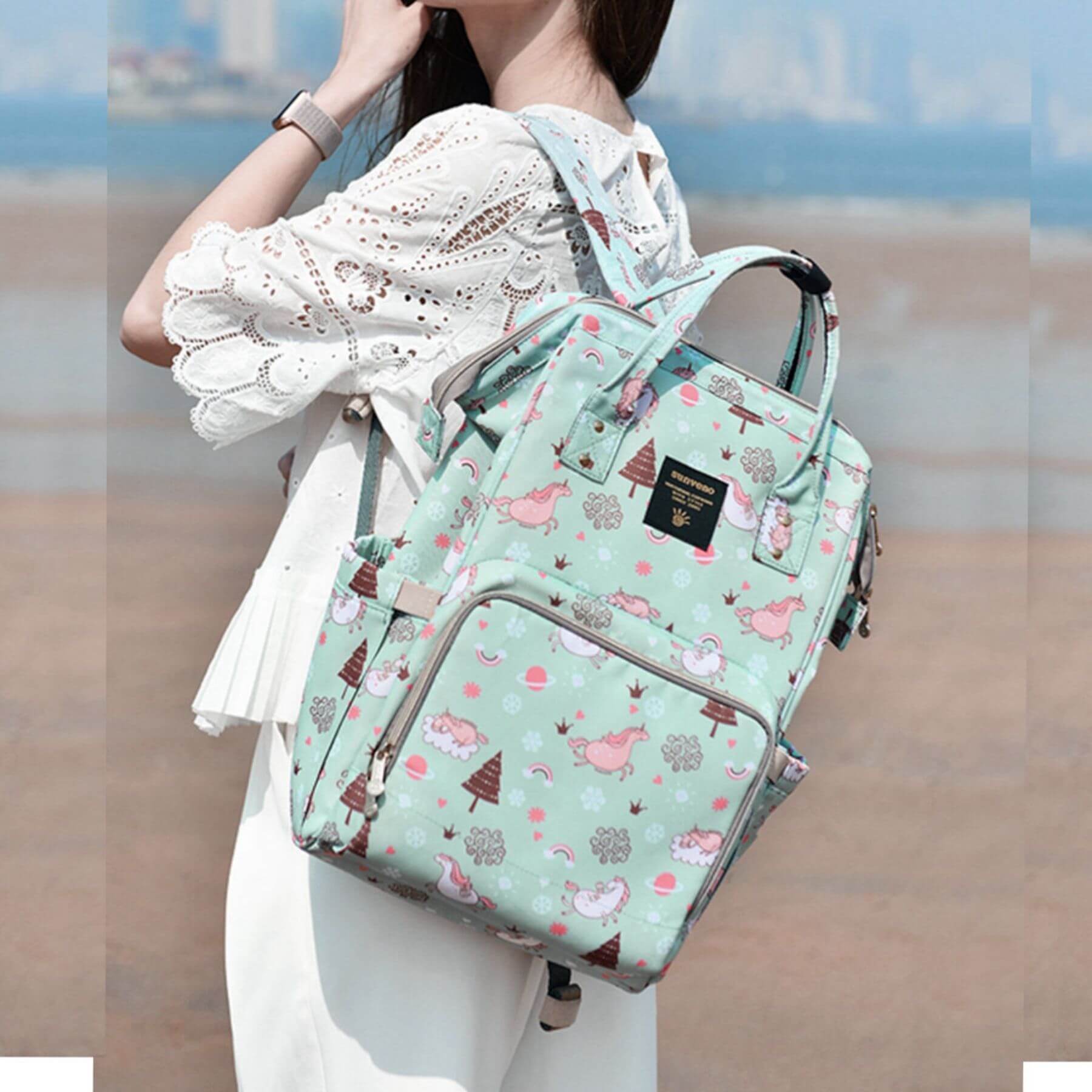 Woman Carrying Sunveno Timeless Baby Diaper Backpack - Green Unicorn