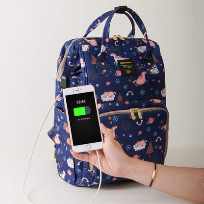 Sunveno Timeless Baby Diaper Backpack - Navy Unicorn with a Hand holding phone