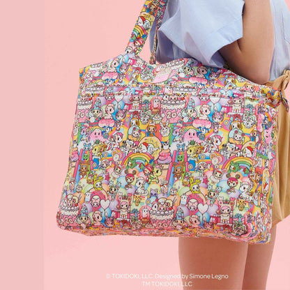 tokidoki Super Be Diaper Bag Tote held by a person on a pink background