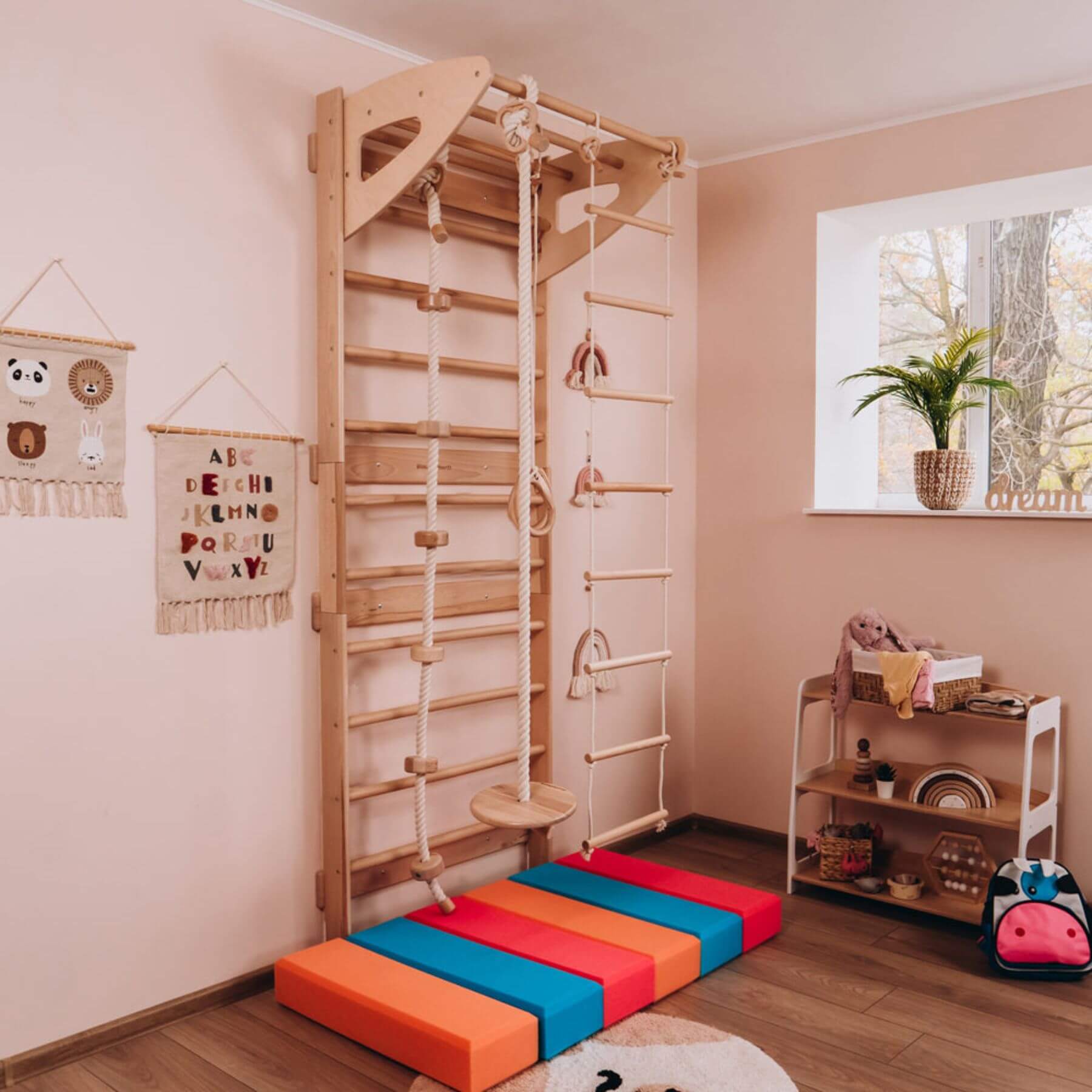Children's playroom with Wood and Hearts Swedish Ladder Gym on the floor.