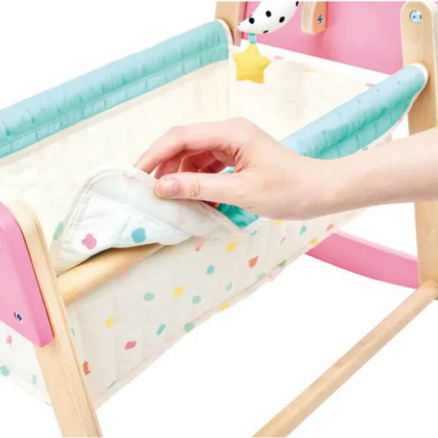 Hand touching Hape Sweet Dreams Doll's Bed
