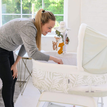 Mom Checking Baby TruBliss Sweetli Calm Bassinet Sage Fern Leaves