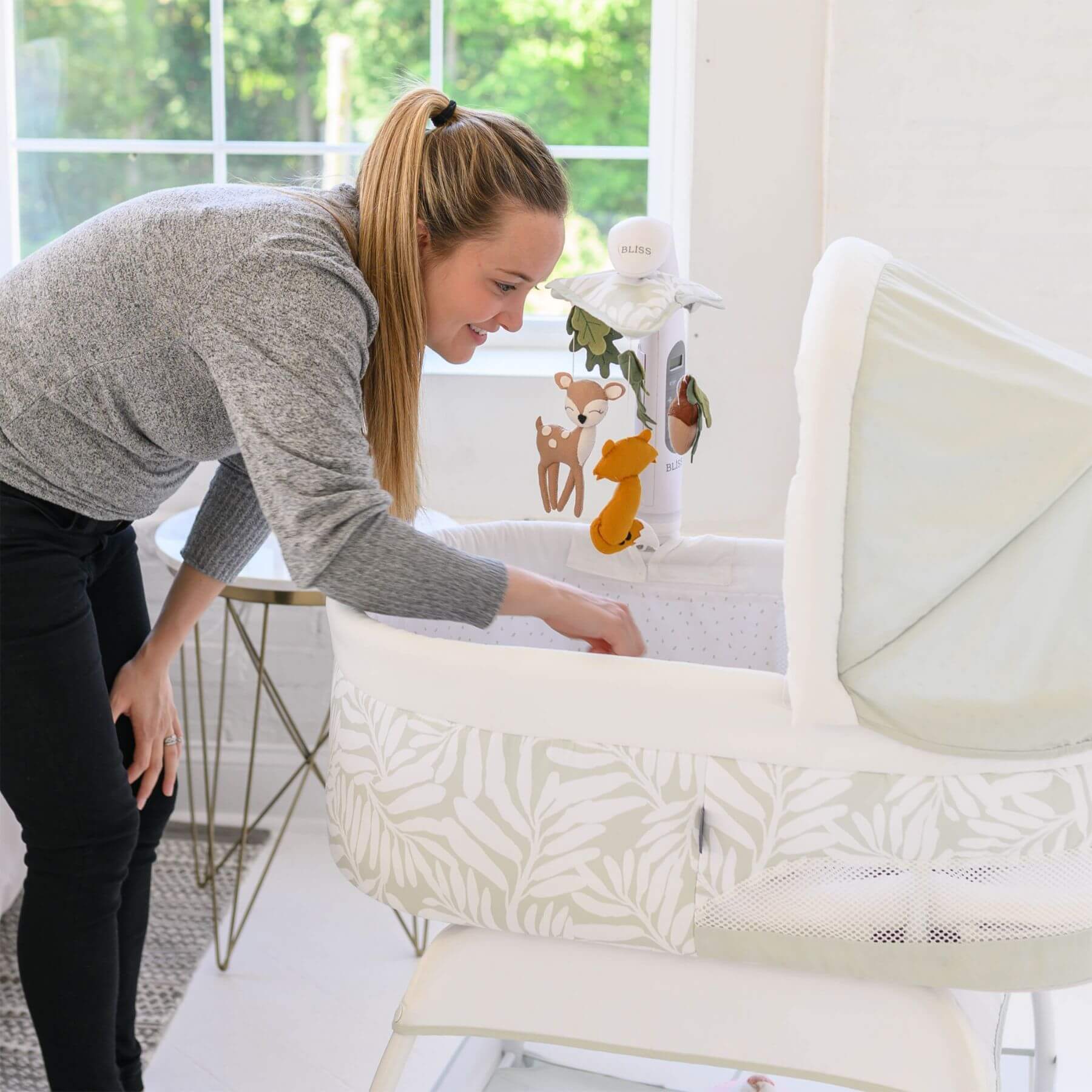 Mom Checking Baby TruBliss Sweetli Calm Bassinet Sage Fern Leaves