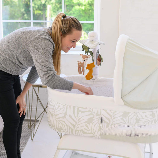 Mom Checking Baby TruBliss Sweetli Calm Bassinet Sage Fern Leaves