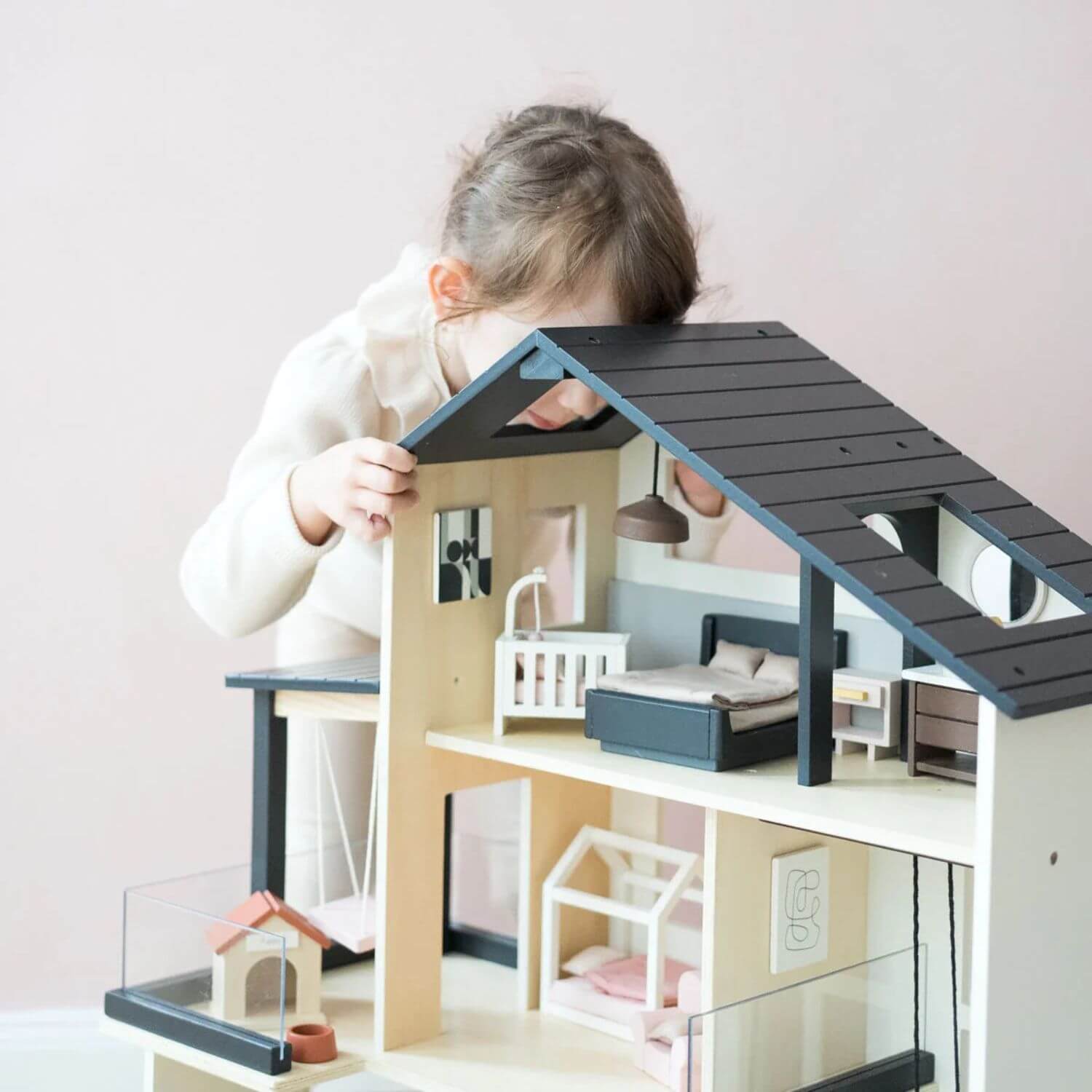 Girl Playing Tiny Land® Sweetwood Edge Dollhouse