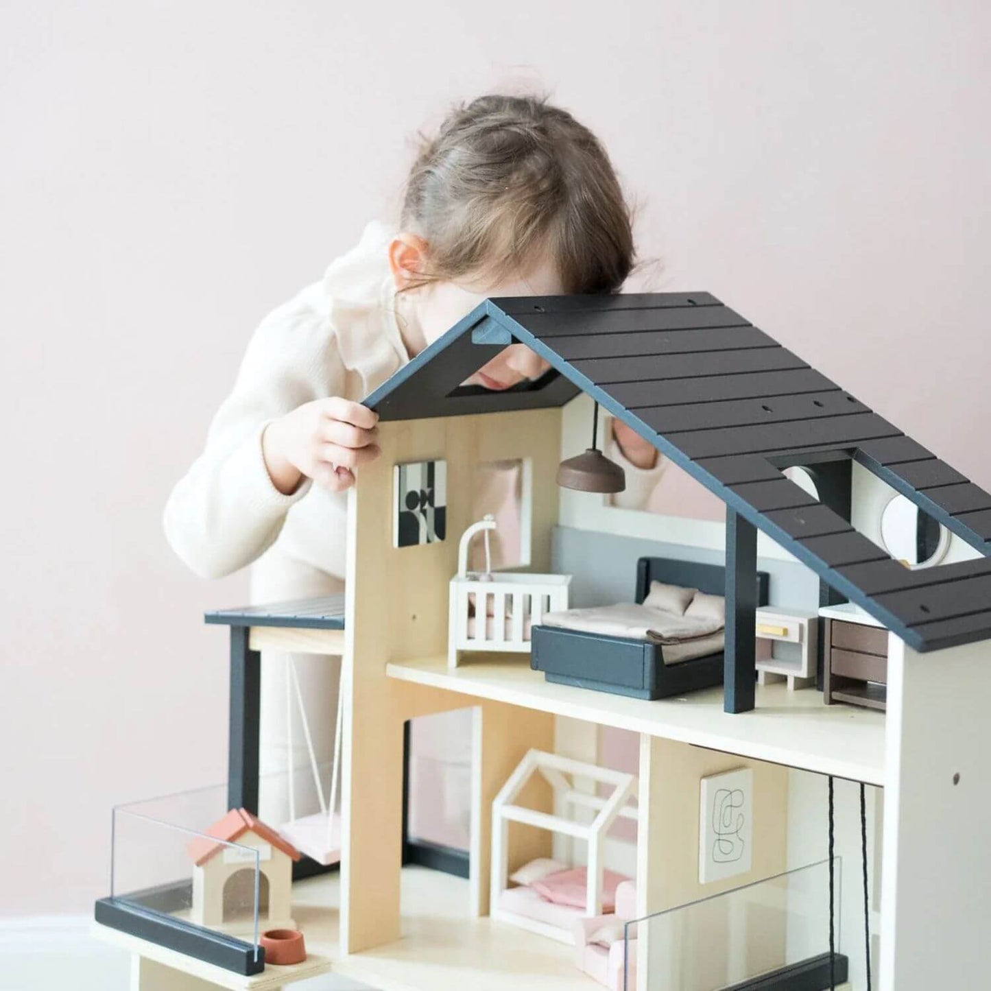 Girl Playing Tiny Land® Sweetwood Edge Dollhouse