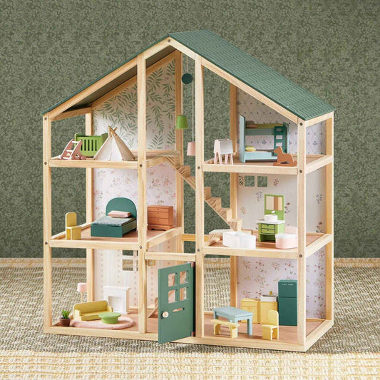 Sweetwood Evergreen Dollhouse with miniature furniture on a textured surface and green wall background