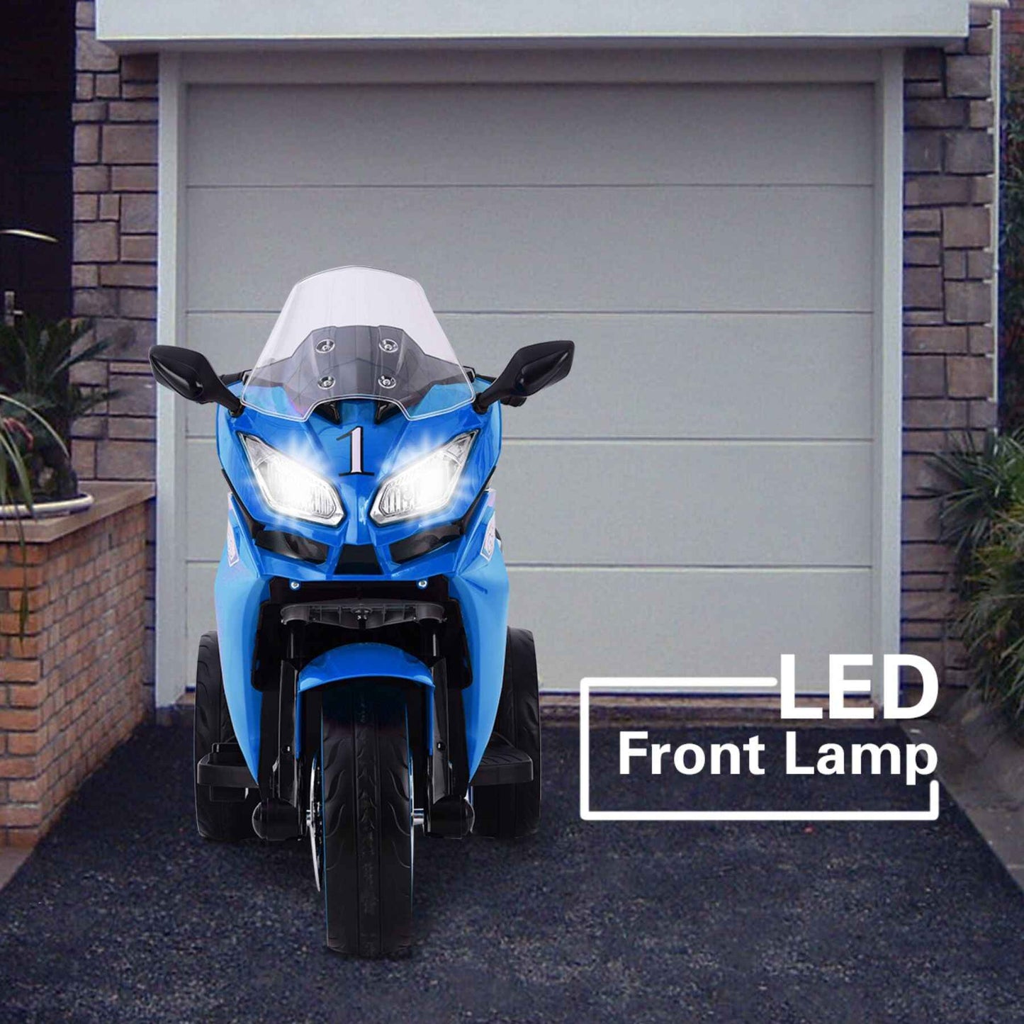 Tamco 12V Kids Electric Ride On Motorcycle - Blue in front of a garage