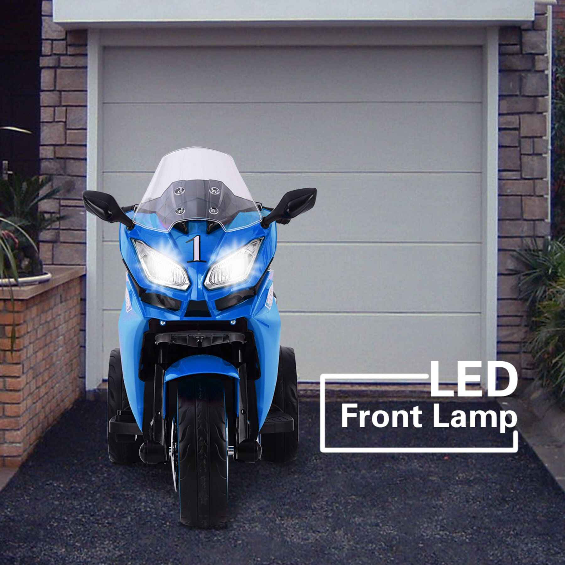 Tamco 12V Kids Electric Ride On Motorcycle - Blue in front of a garage