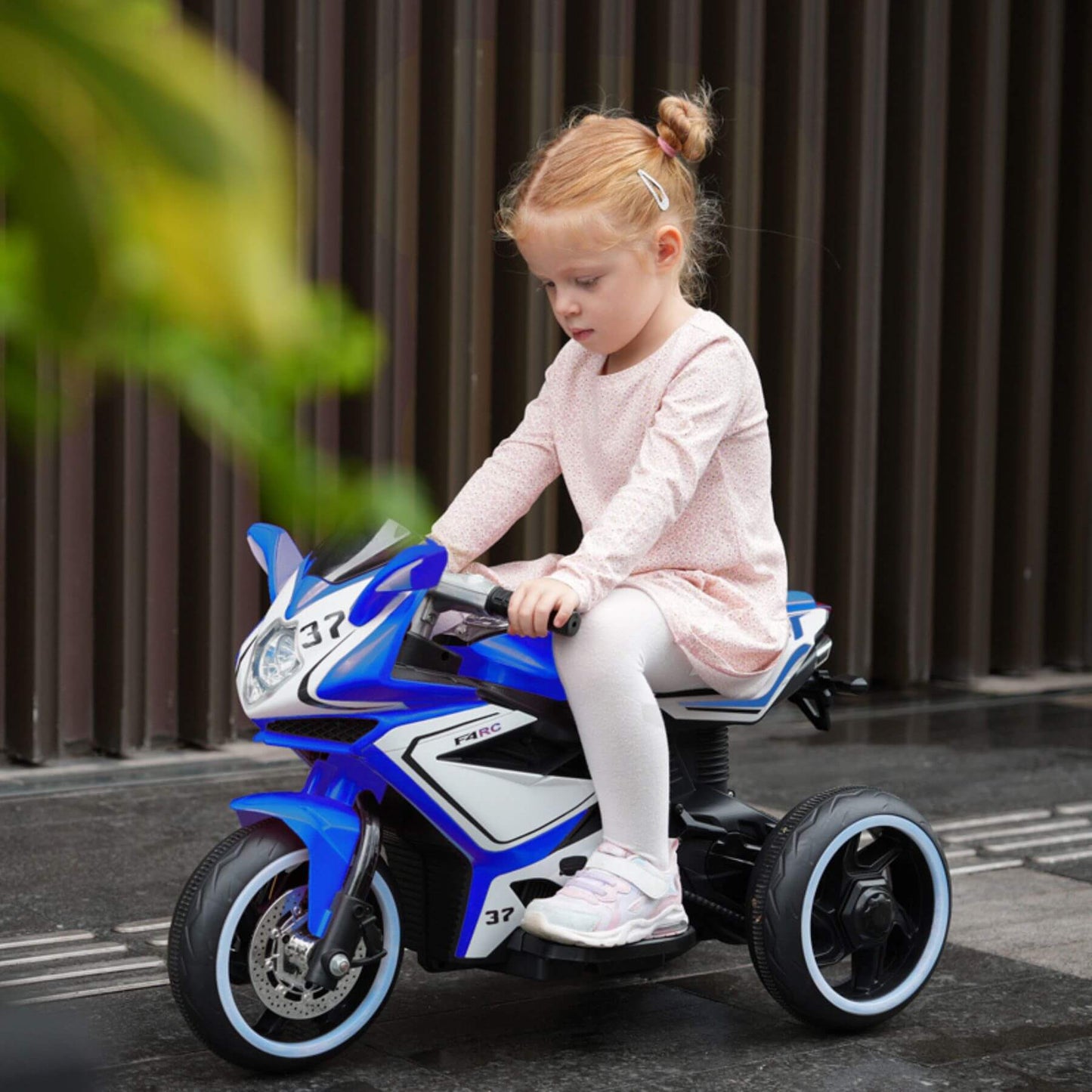 Child riding Tamco 6V Kids Electric Motorcycle for 3-4 Years Boys - Blue on a street.