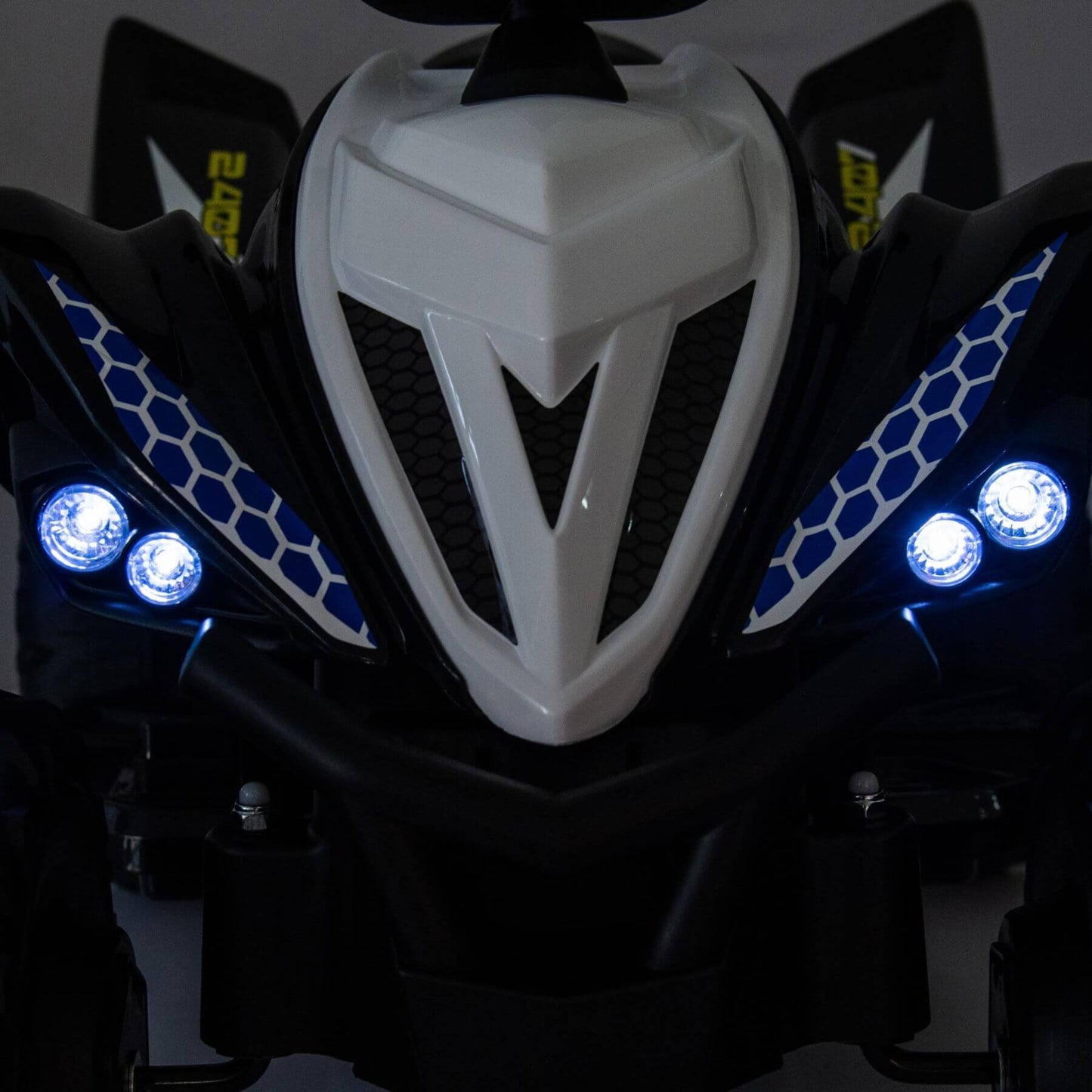 Close-up of Tamco Kids Dual Motor Electric Ride On Toy - Blue on a dark background