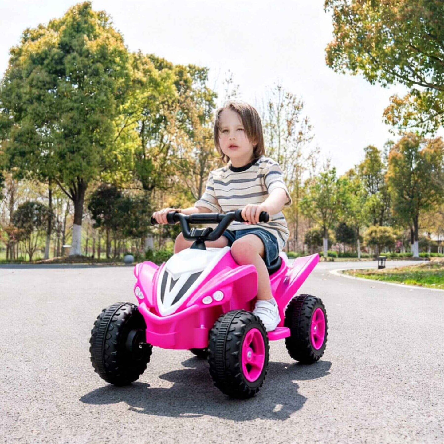 Child riding Tamco Kids Dual Motor Electric Ride On Toy - Pink on a road with trees in the background