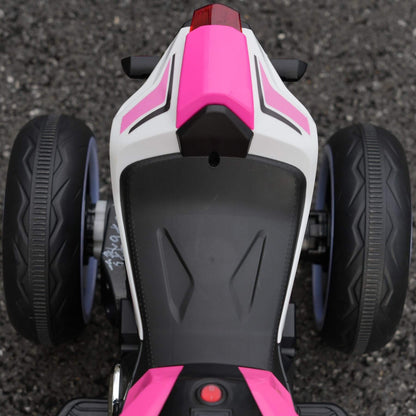 Close-up of a pink and white toy motorcycle on a dark surface