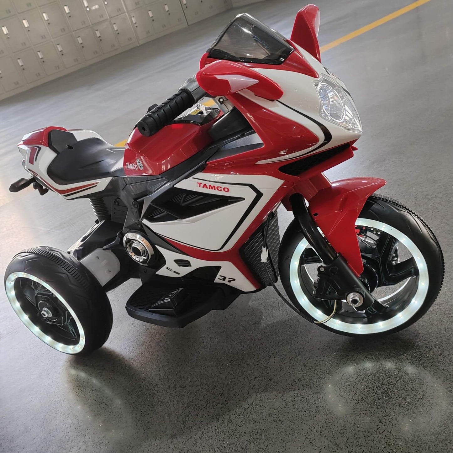 Tamco 6V Kids Electric Motorcycle - Red on a concrete floor.