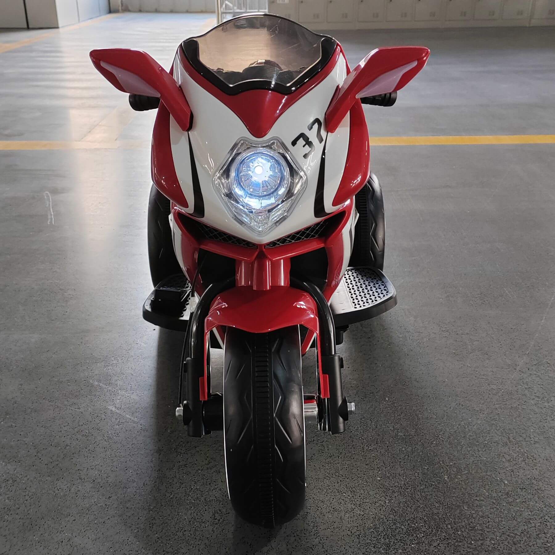 Tamco 6V Kids Electric Motorcycle - Red on a gray floor.