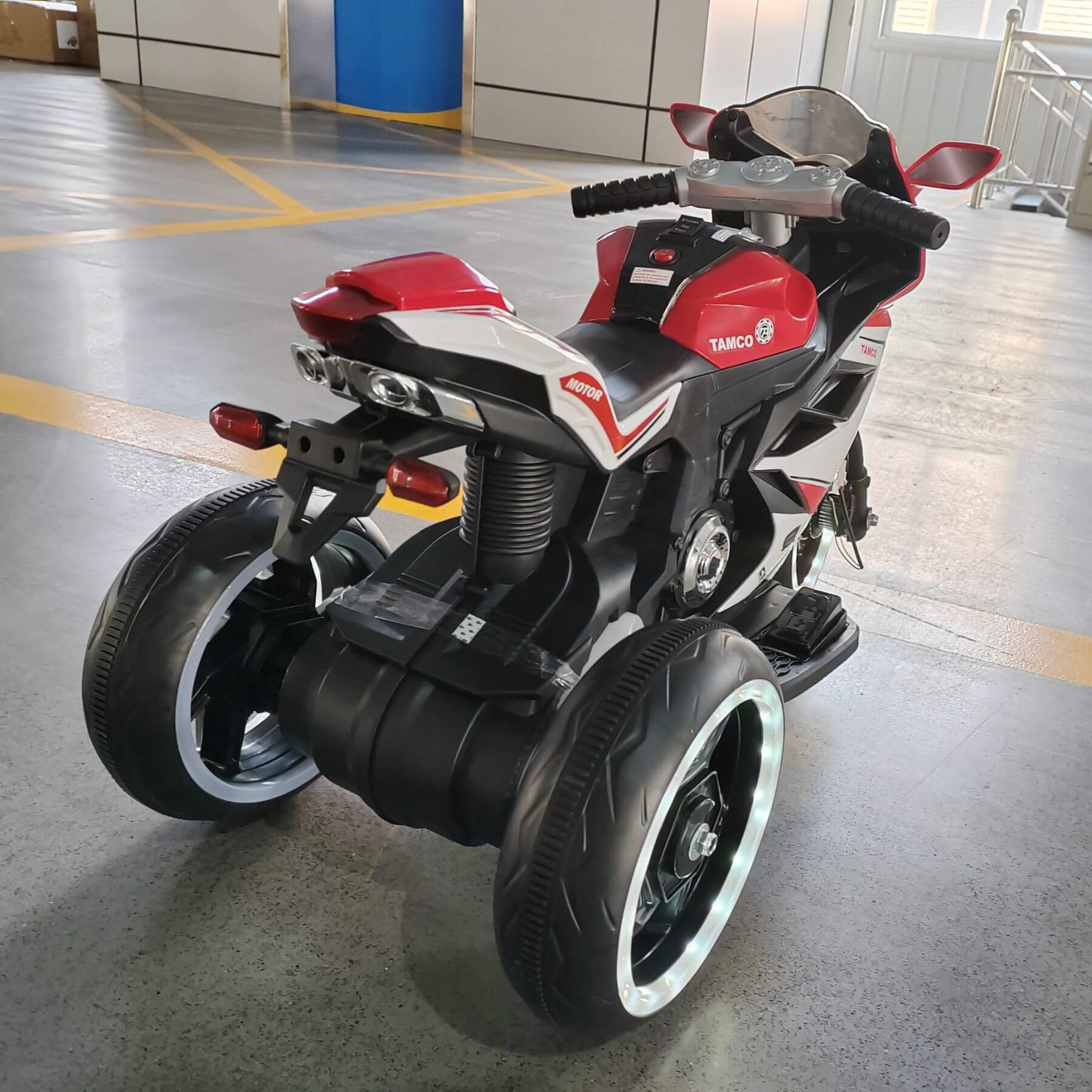 Tamco 6V Kids Electric Motorcycle - Red on a concrete floor.