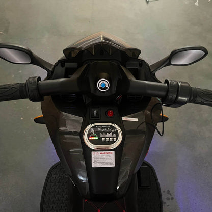 Close-up of a motorcycle's handlebar and dashboard against a gray background