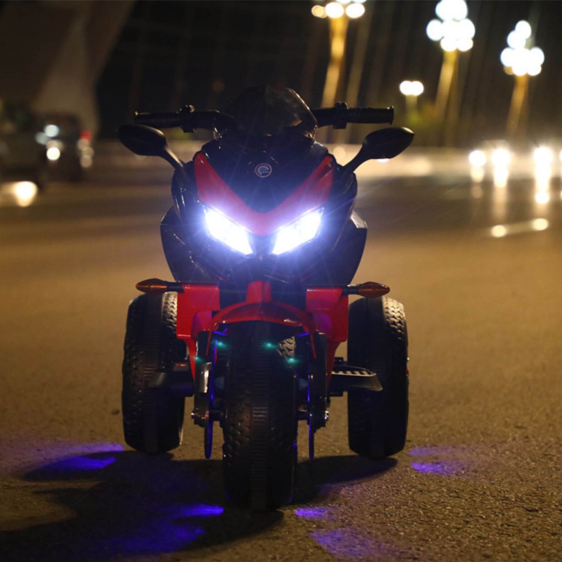 Motorcycle with glowing headlights on a street at night