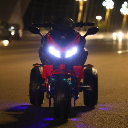 Tamco Kids Motorcycle Ride-On 3-Wheels Motorbike - Red on a street at night with headlights on