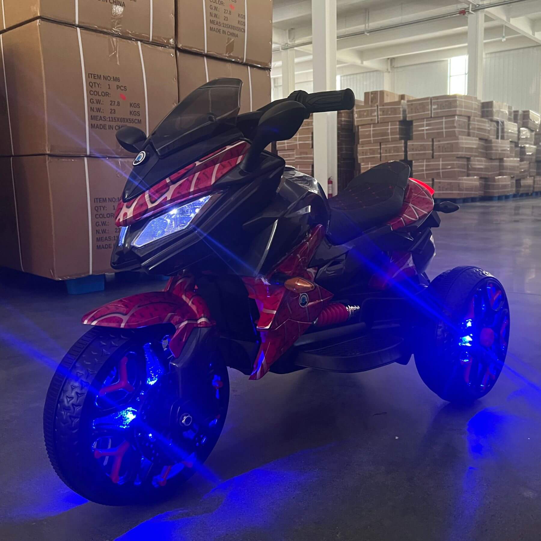 Tamco Kids Motorcycle Ride-On 3-Wheels Motorbike - Red in a warehouse setting