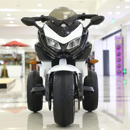 Children's toy motorcycle with BMW logo in a mall setting