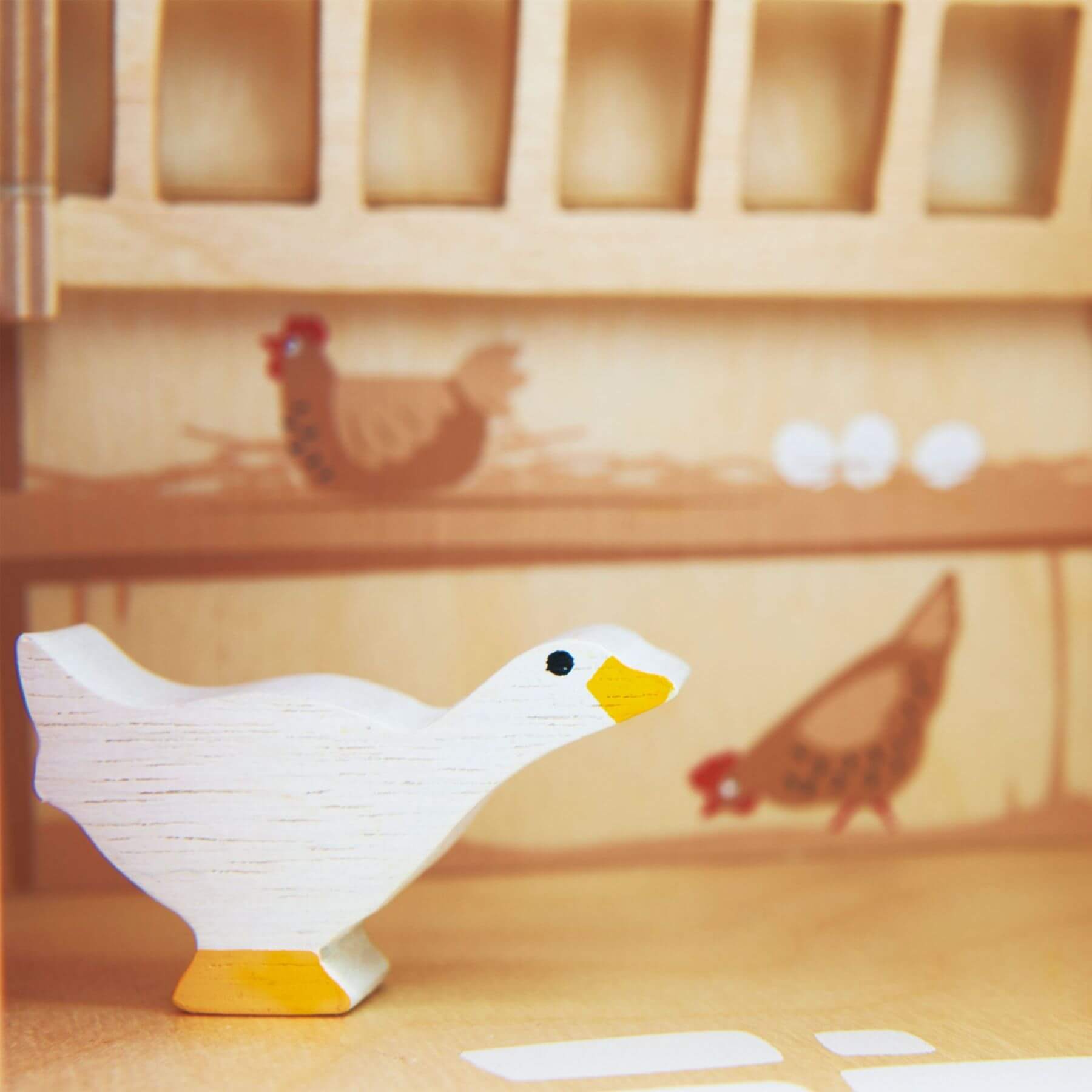 Wooden duck toy on a wooden surface with blurred background