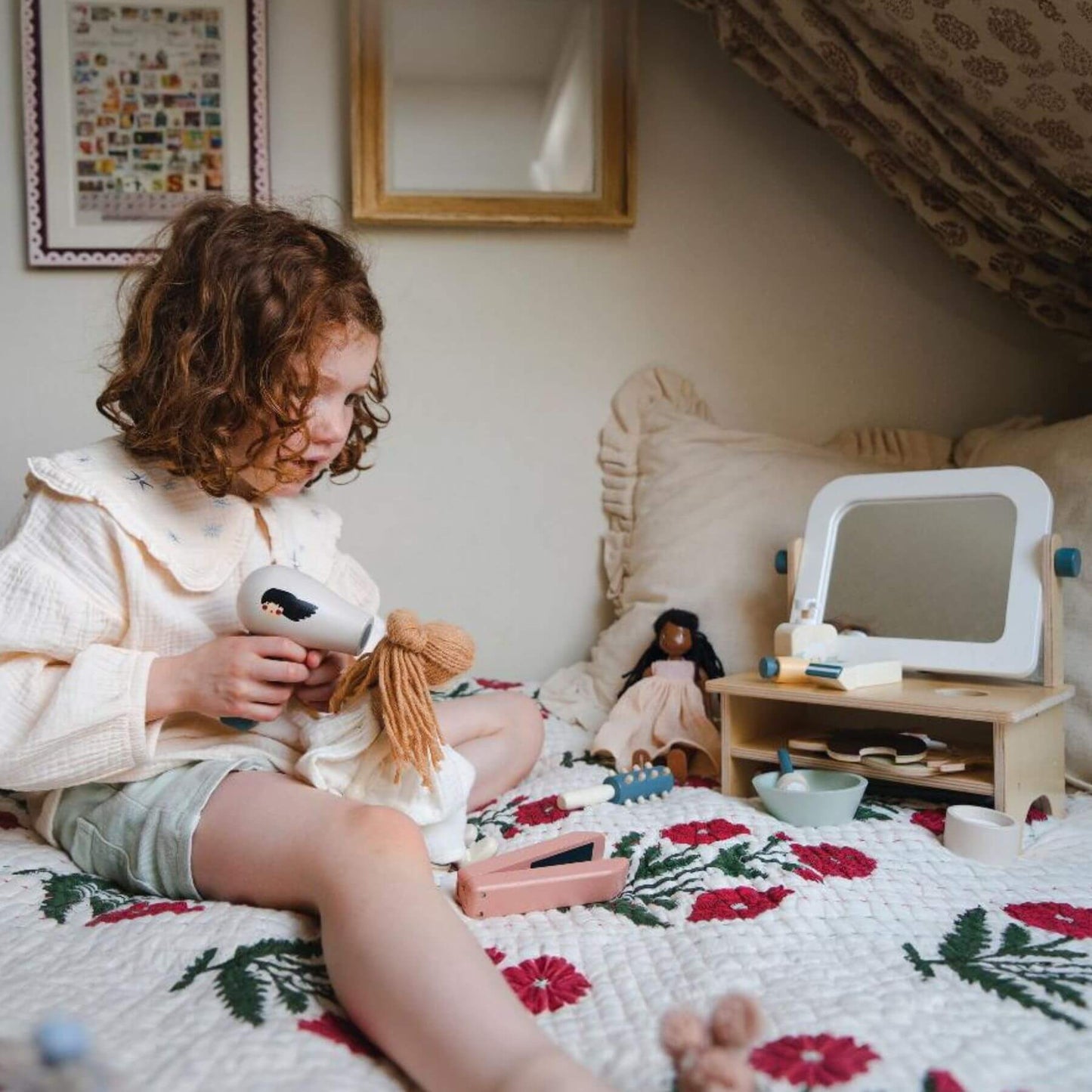 Child playing with Tender Leaf Hair Salon on a bed in a bedroom